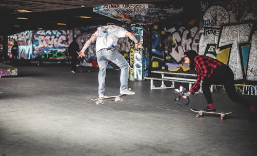 A dynamic shot of a sponsored skater mid-trick wearing Sentra Skate gear at an urban skate park.