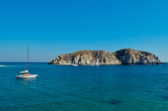 A serene ocean view showcasing sailing boats under clear skies.