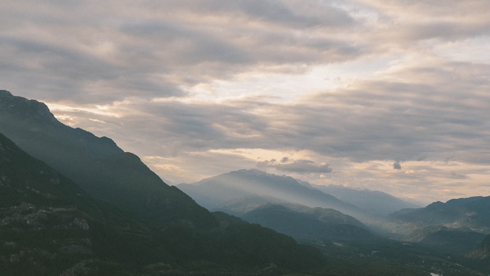 a view of a valley with mountains in the background