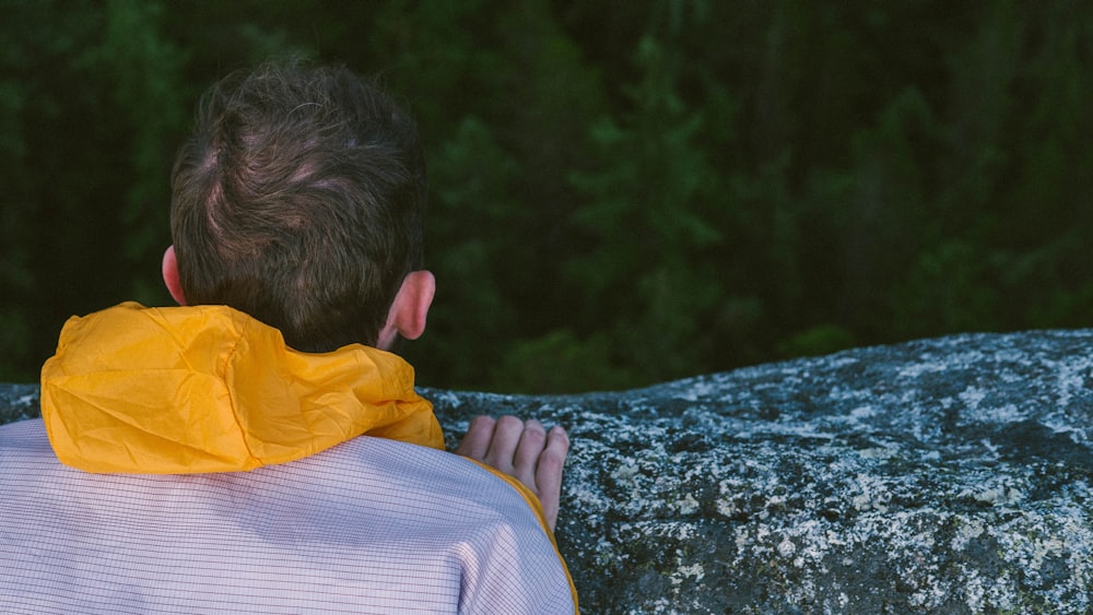 man looking down on forest