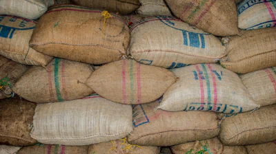 Close-up of colorful polypropylene sacks stacked neatly in a warehouse.