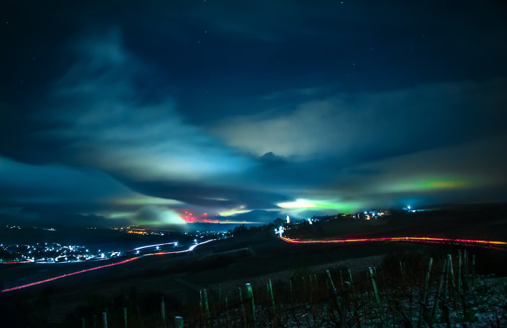 green grass field under blue sky during night time