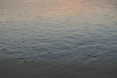 A serene hyperbaric chamber room bathed in soft blue lighting reflecting ocean waves.