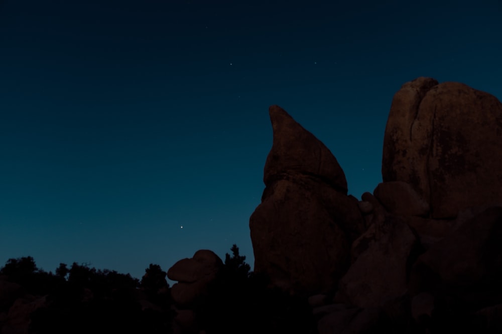 brown rock formation under blue sky during nighttime