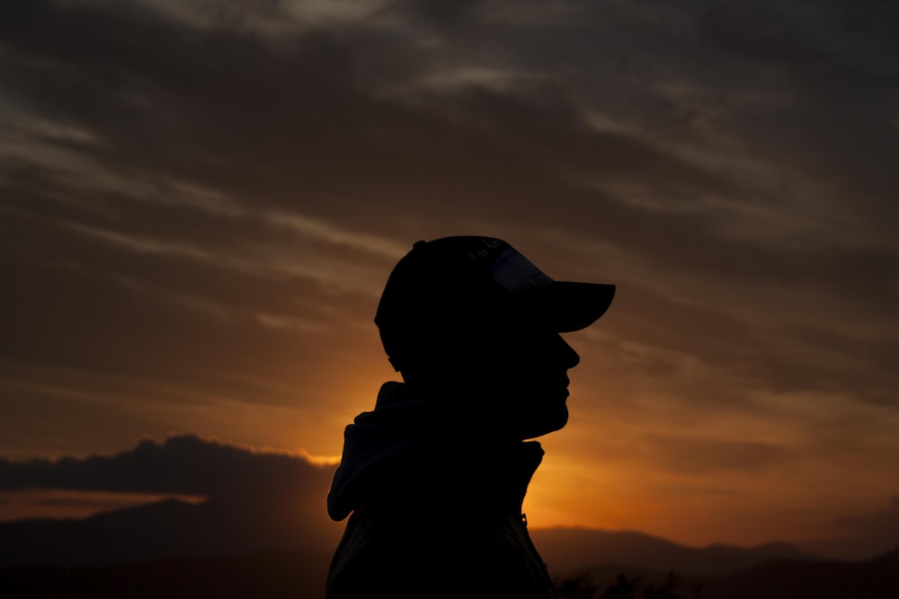 person's silhouette during golden hour