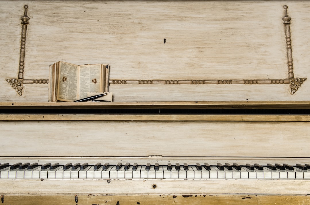 brown music book on piano, Worn-out white piano