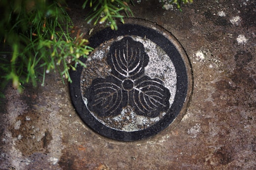 An ancient, weathered symbol glowing softly against a dark, mystical background.