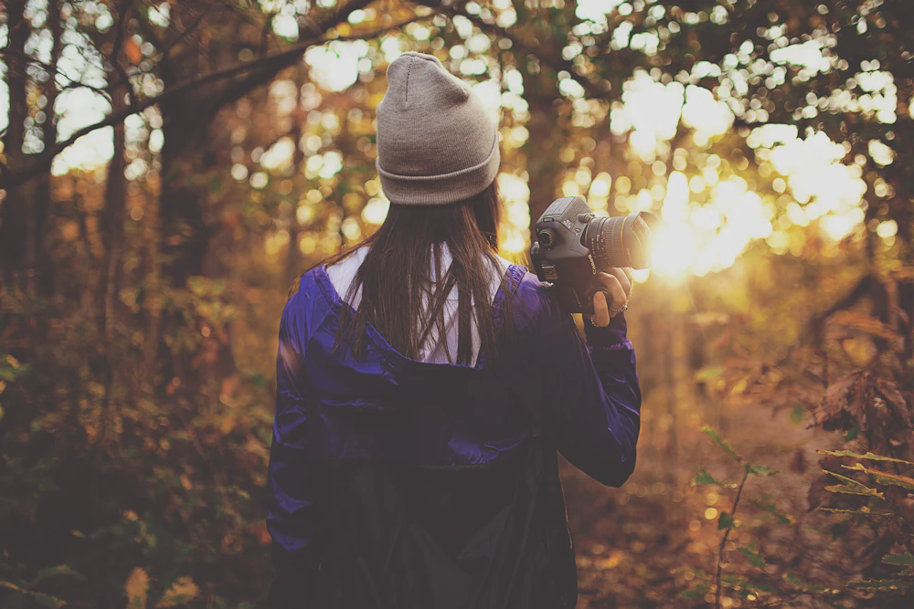 Wren Calloway, photographer, working in a forest clearing during golden hour