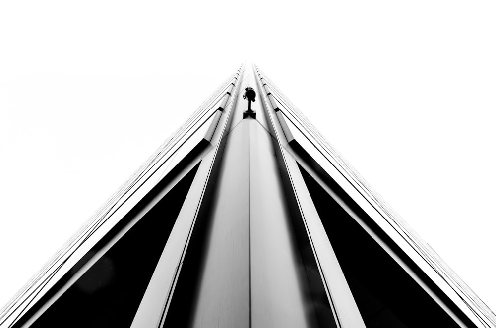 A monochrome shot of a sharp edge on a corner of a tall building