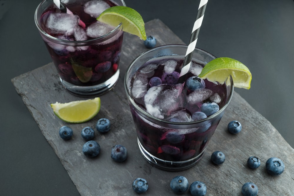 rock glasses surrounded by blackberries