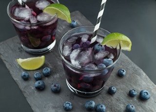 rock glasses surrounded by blackberries