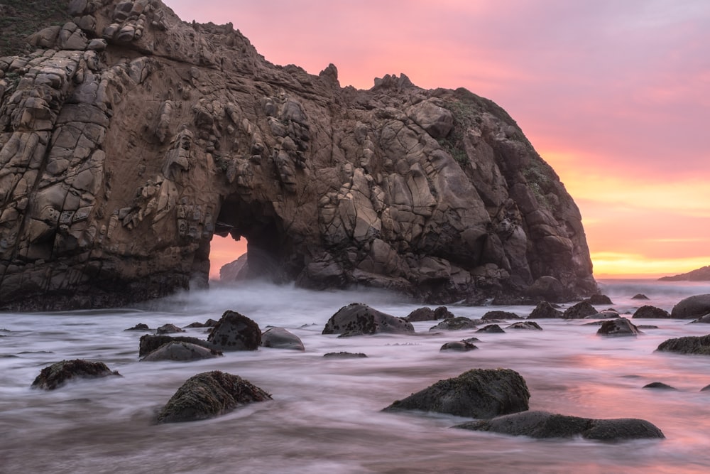 rocky ocean near tunnel