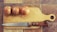 A wooden cutting board placed on a tiled surface with three whole onions lined up on top. A knife with a wooden handle is resting next to the onions.