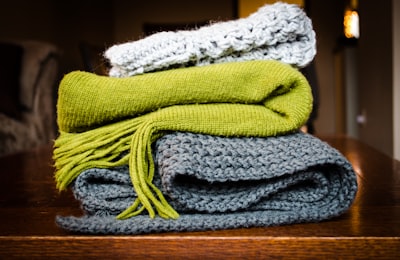 three gray, green, and white scarf on top of table scarf google meet background