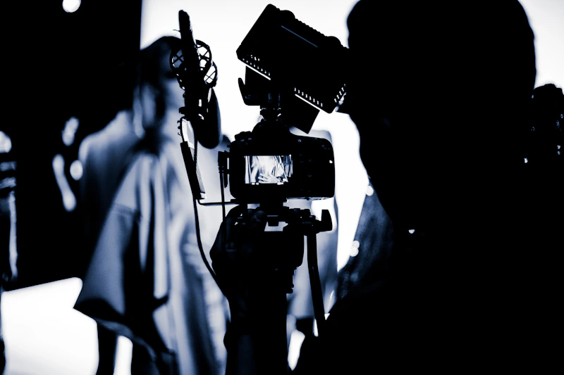 A cinema camera rigged and ready on a darkened set