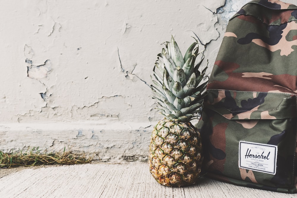 pineapple fruit beside Hershel backpack