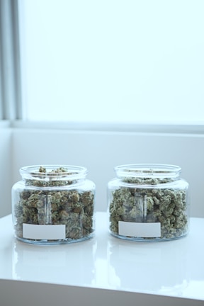 full of kush in clear glass jars on table