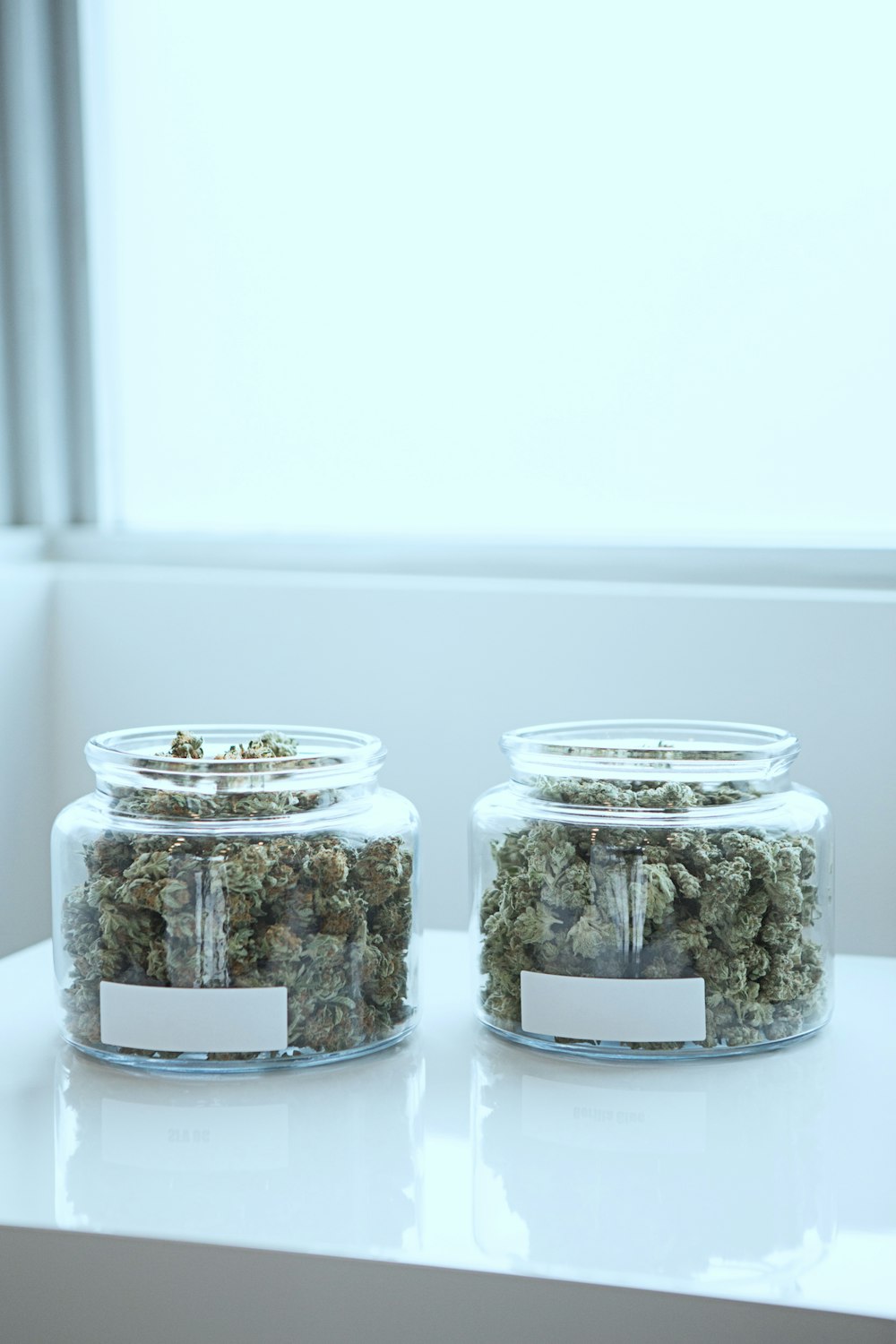 full of kush in clear glass jars on table