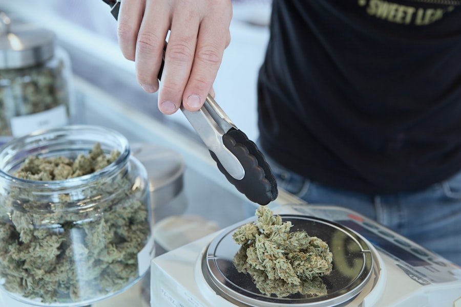 Budtender using tongs to handle cannabis flower at a dispensary counter