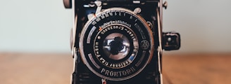 black Prontor II camera on brown wooden board