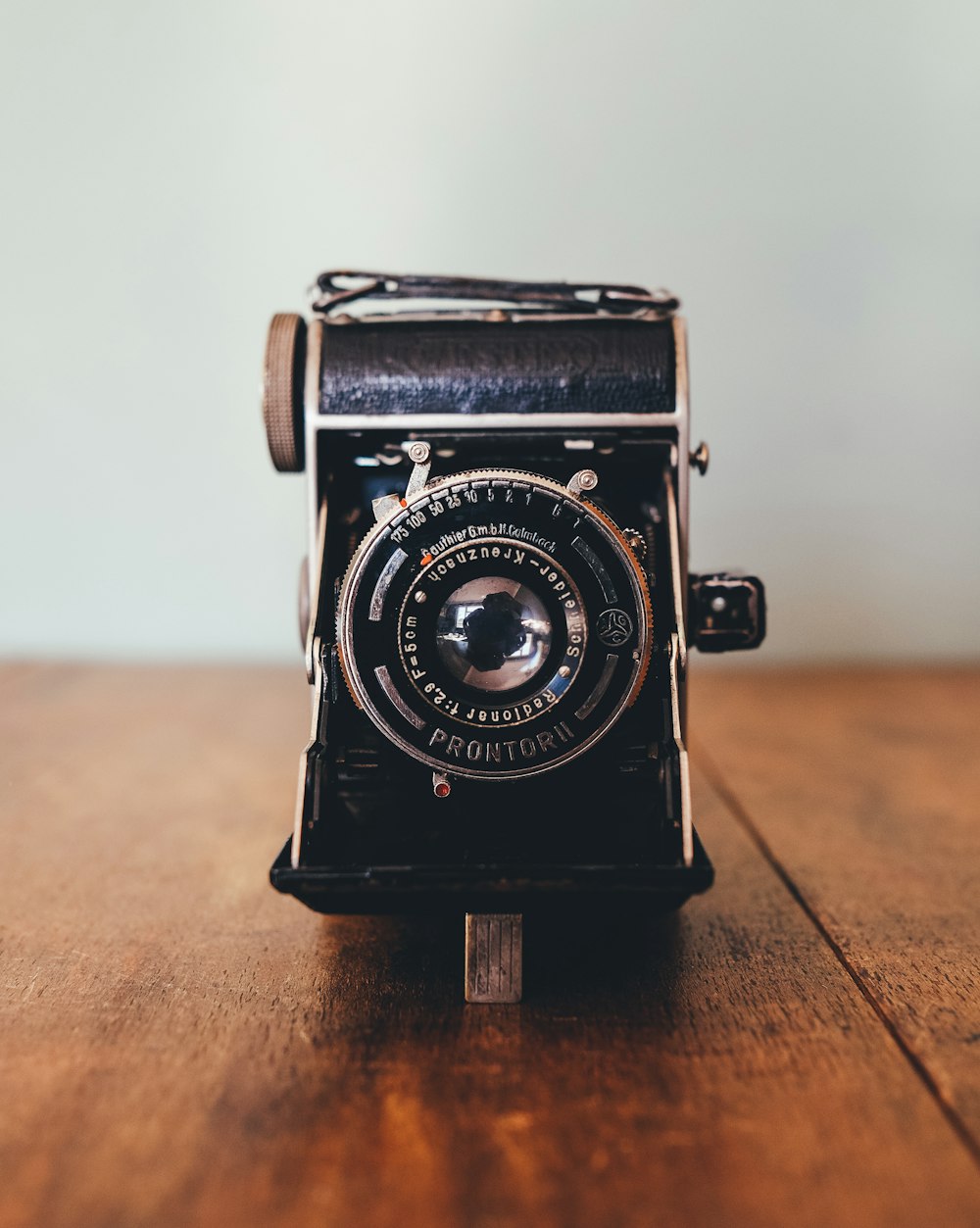 black Prontor II camera on brown wooden board