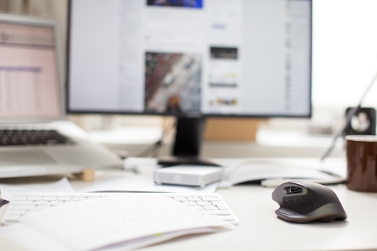 Photo of a messy desk with empty coffee cups and a laptop showing a half-broken webpage.