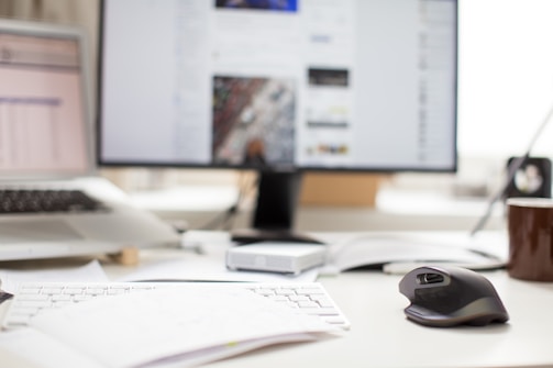 An office desk with a computer and paperwork.