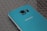 A blue Samsung smartphone resting on bubble wrap, showcasing its rear camera and metallic blue finish.
