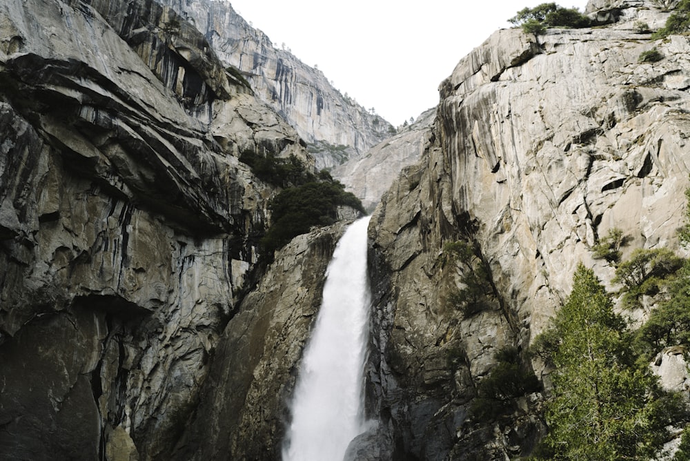 waterfalls between rocky mountain during daytime