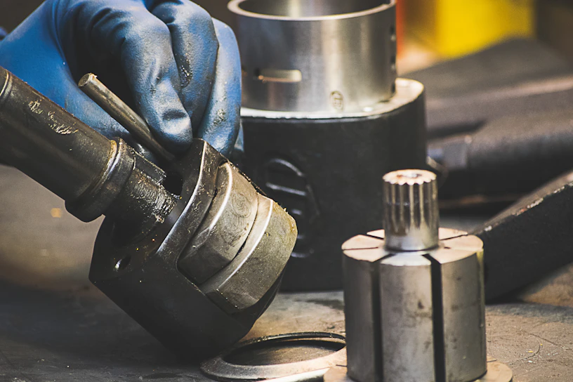 Close-up of a mechanic's hands carefully assembling a durable automotive gear.