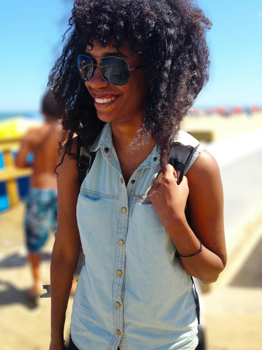 A happy African American backpacking female.