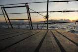 Sunset over Igaratá lake seen from the wooden deck of a luxury floating boat.