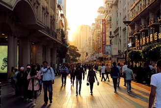 A vibrant street scene in Guangzhou's bustling market district at sunset.