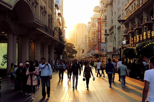 A vibrant street scene in Guangzhou's bustling market district at sunset.