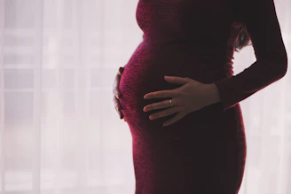 A gentle prenatal massage being given to a pregnant client in a peaceful room.