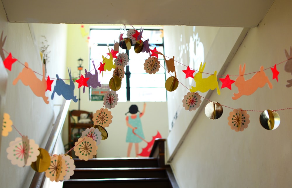 A school hallway decorated with bunnies, stars, and polka dots with a girl holding an umbrella painted on the wall in Singapore