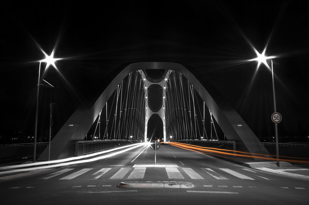 white and black bridge during night time