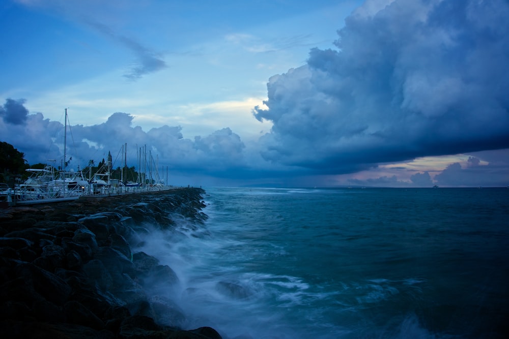 ocean wave under cloudy sky