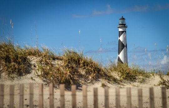 black and white lighthouse in seashore in Cape Lookout United States
