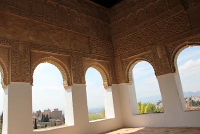 Traditional Arabian architecture with intricate geometric patterns under a clear blue sky.