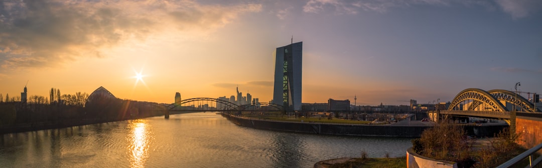 bridge over water near city buildings during daytime