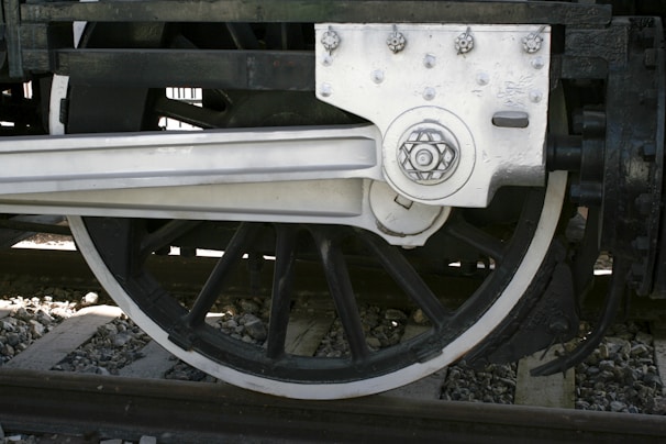 A close-up of a railway wheel showcasing its intricate design.