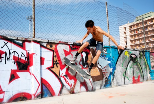 boy playing skateboard during daytime in Lloret de Mar Spain