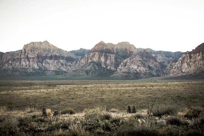 Open desert flats in front of a mountain ridge, showing the scale of undeveloped land near Boulder City