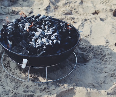 black fire pit on sand