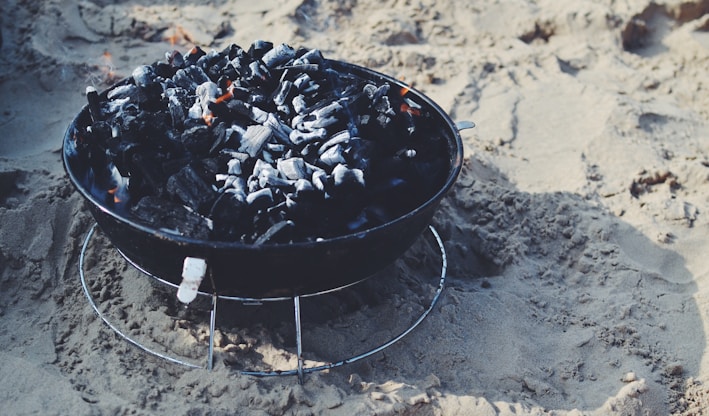 black fire pit on sand