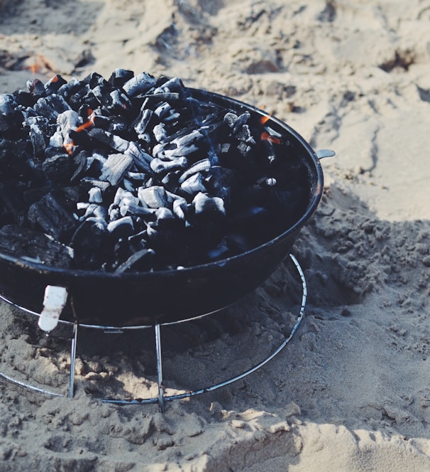 black fire pit on sand