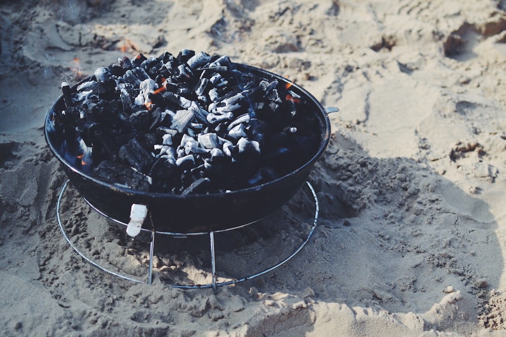 black fire pit on sand