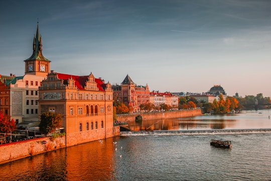 photo of boat on body of water near high-rise buildings in Praha Czech Republic