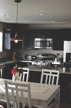Modern kitchen with stainless steel appliances and granite countertops.